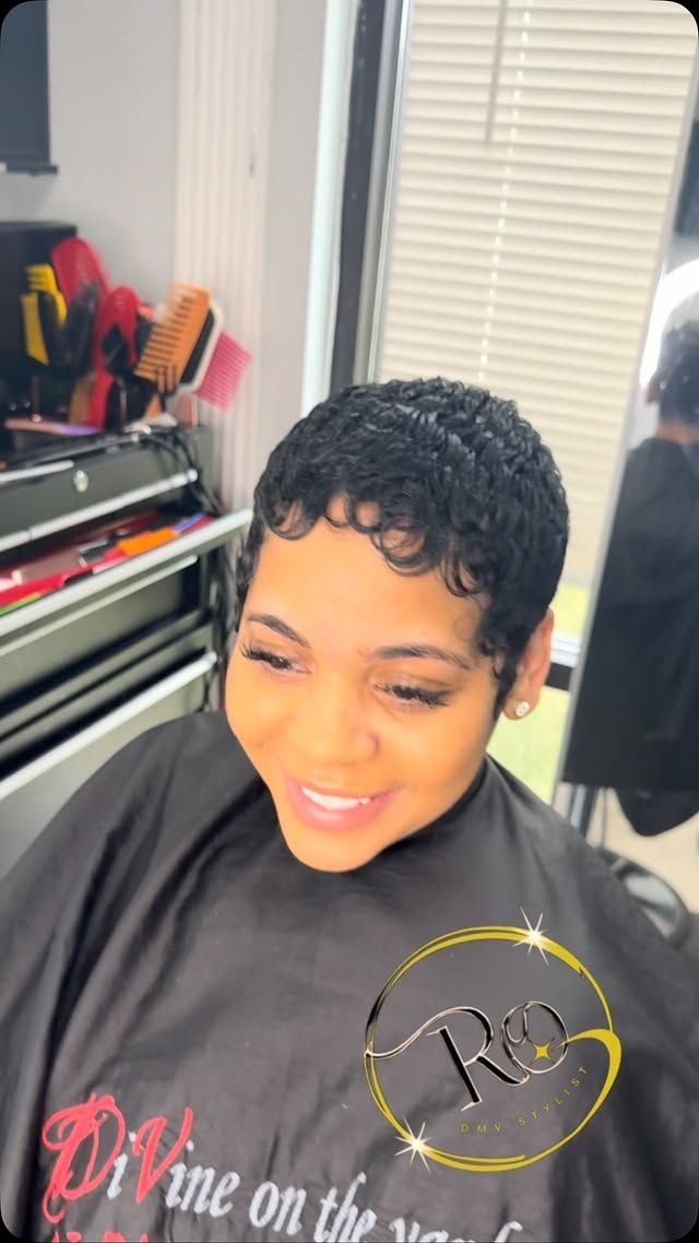 Glossy short pixie with sculpted edges, styled in the chair